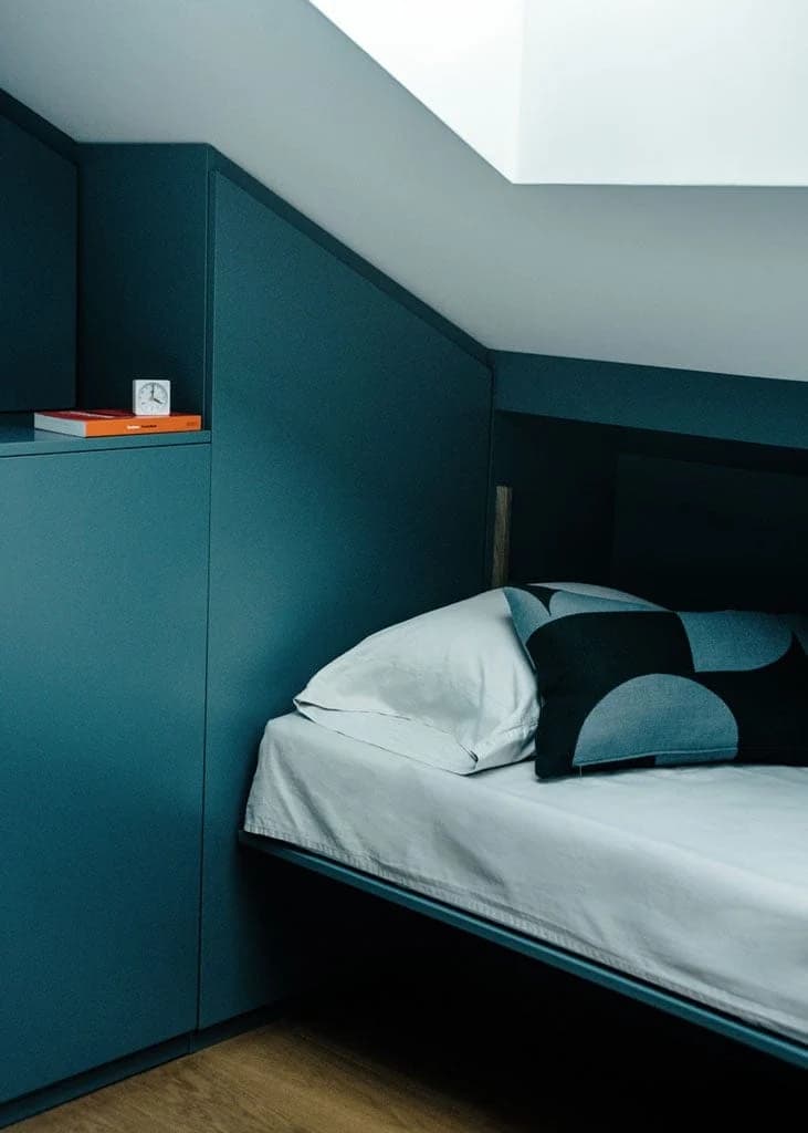 Cozy modern bedroom corner with minimalist design and warm light.
