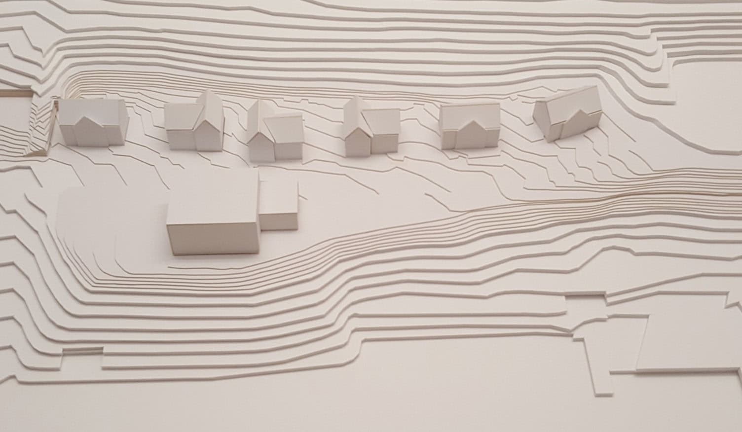Cardboard architectural model of the buildings and terrain.