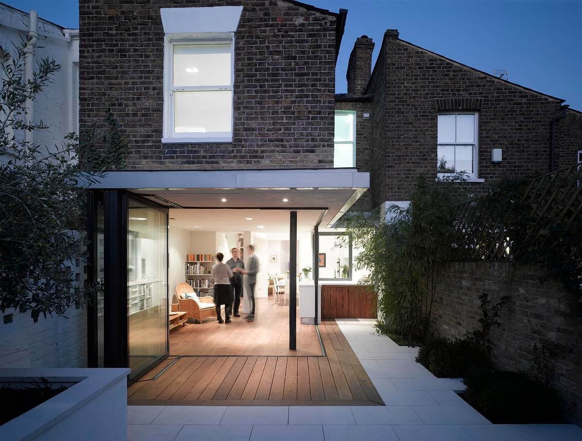 Illuminated rear extension at dusk.