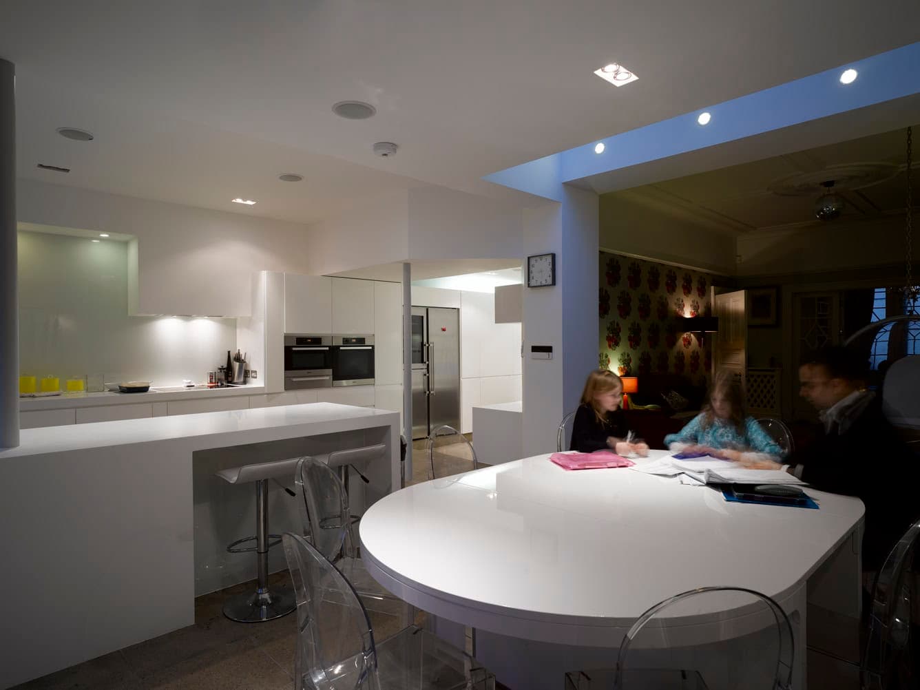 Dining area illuminated at night.