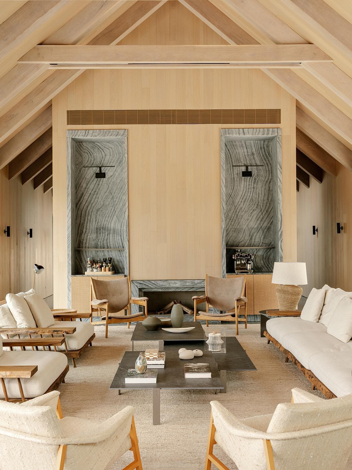 Stylish modern living room with vaulted ceilings, natural materials, and inviting seating arrangements.