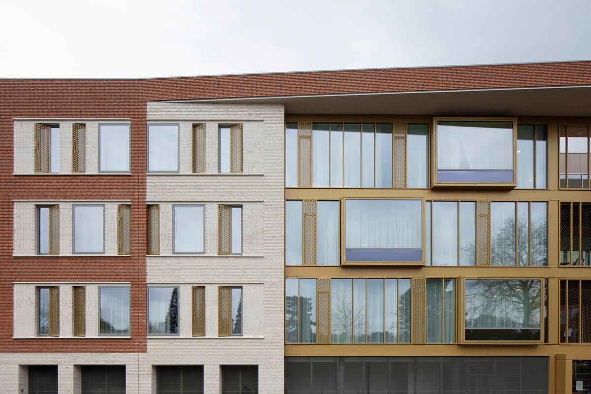 Modern healthcare clinic facade with mixed brick and large glass windows.