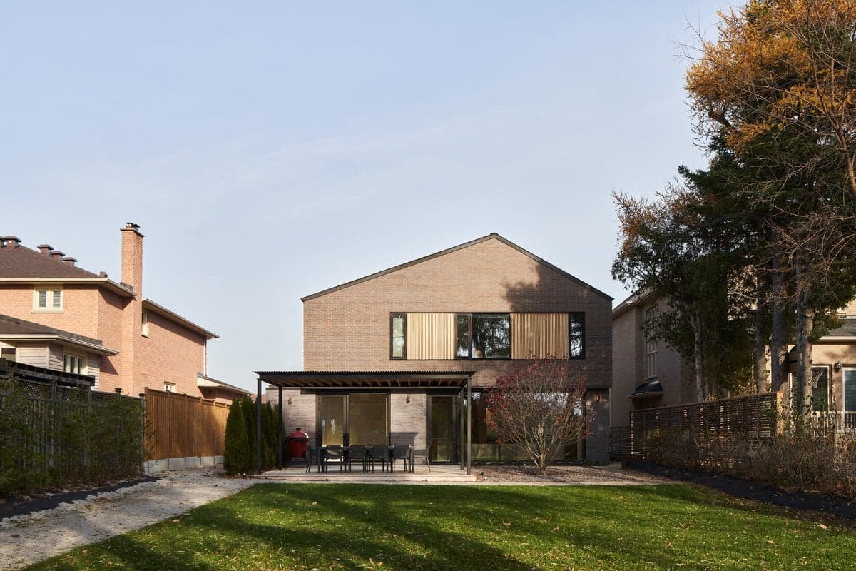 Modern two-story house with patio and lawn in suburban Toronto.