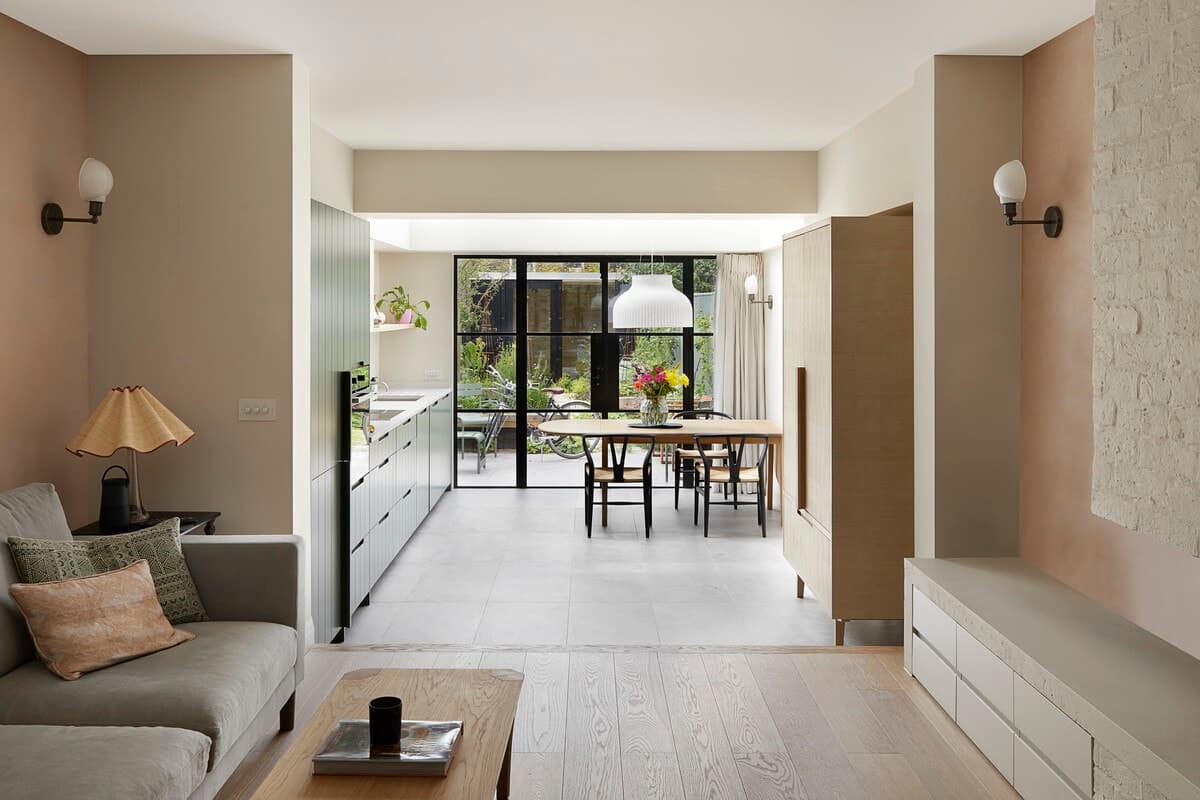 Modern open-plan living room, kitchen, and dining area with natural light in Wandsworth Cottage.