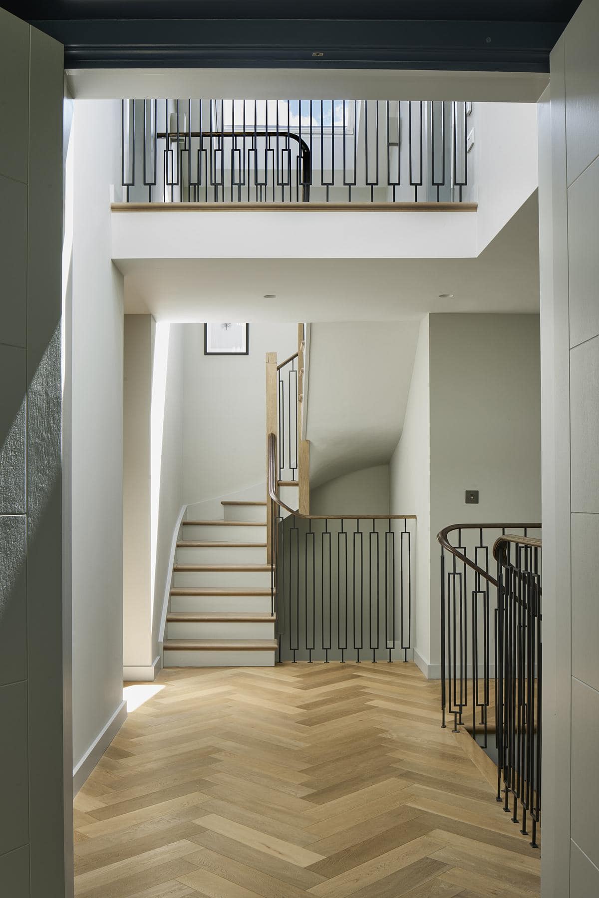 Stylish modern staircase design in a contemporary home with wooden steps and minimalist railings.