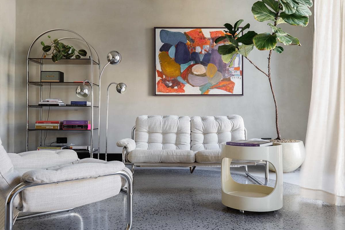 Vintage seating and local artwork shape the living space in FA.