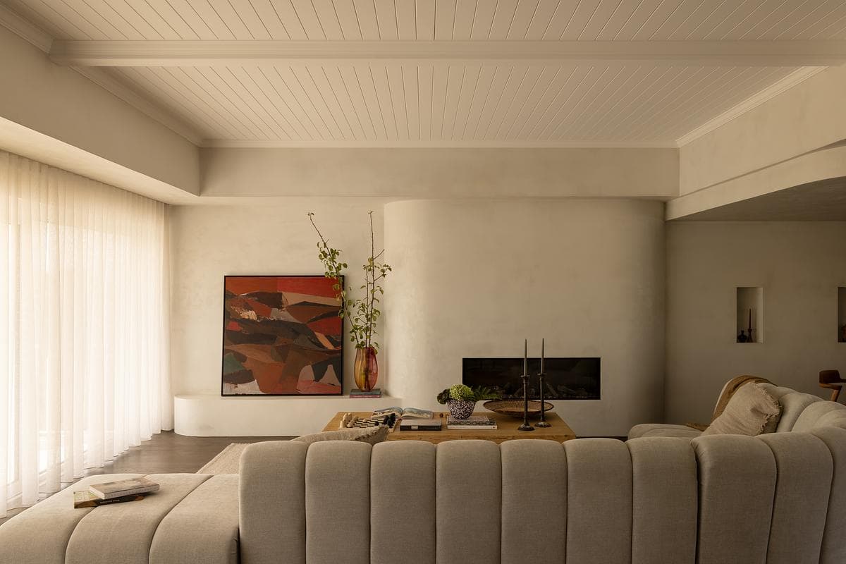 A curved sofa defines the renewed upper-level living room.
