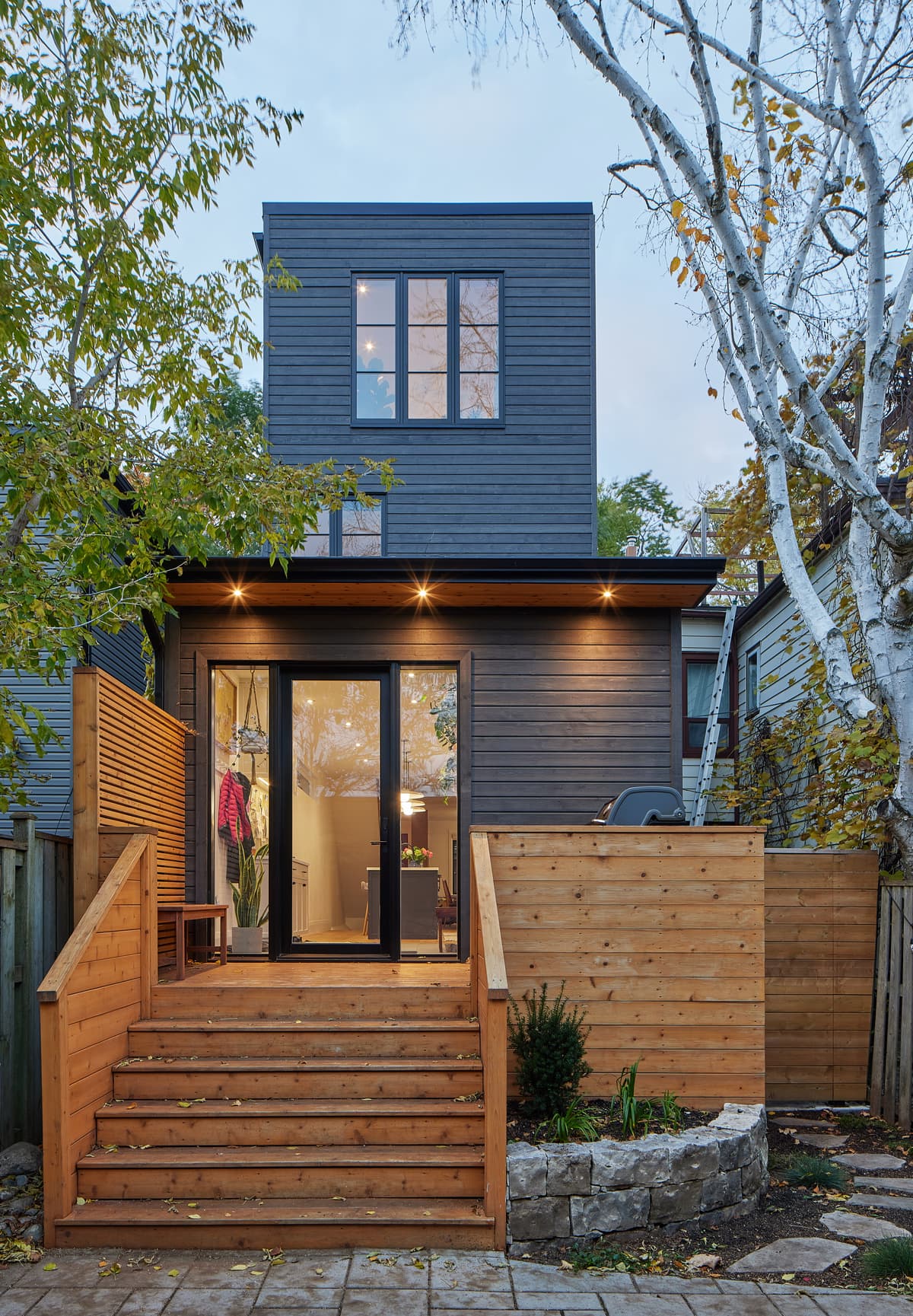 A dark-clad upper addition above the rear terrace.