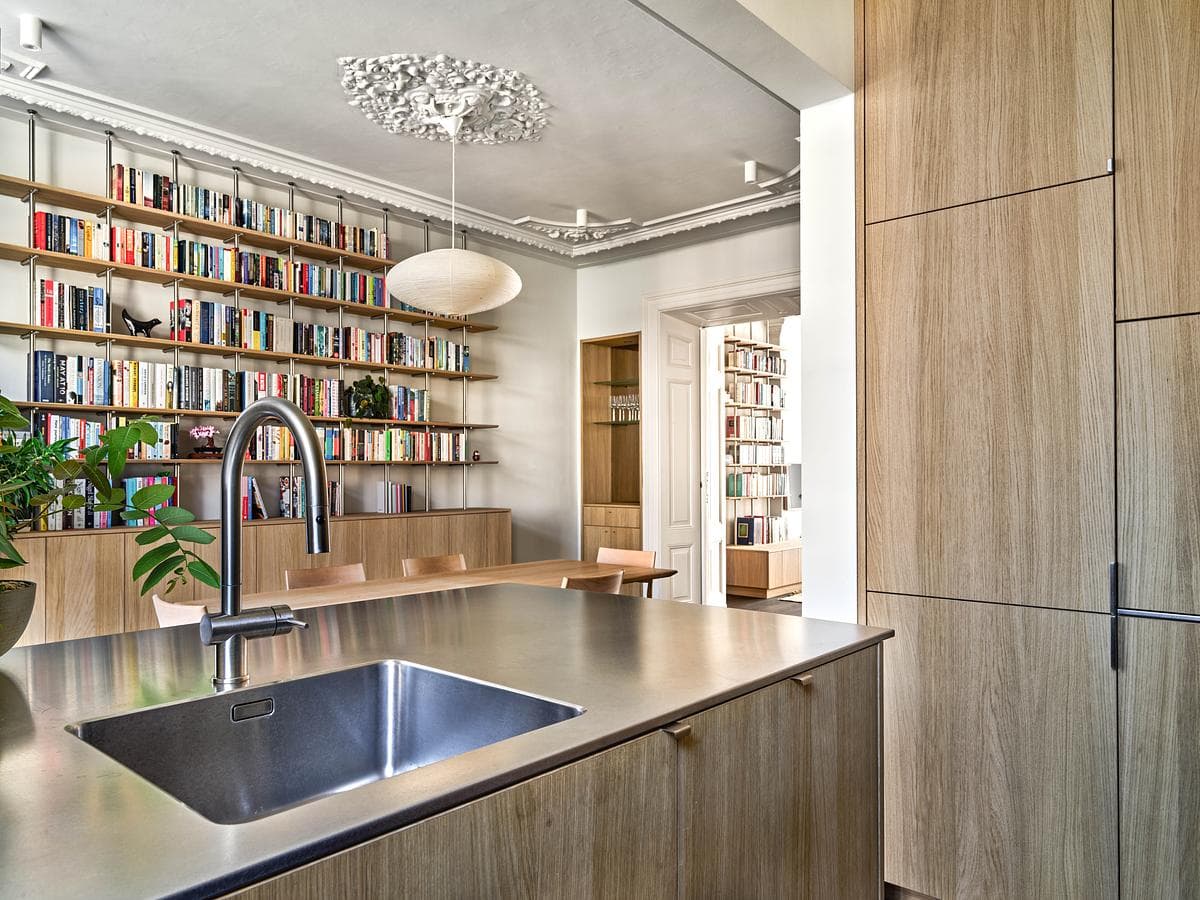 View from the kitchen counter towards the dining room and bookshelves