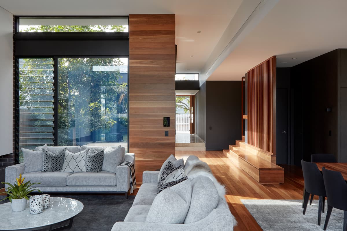 Timber surfaces and broad glazing surround the living space.