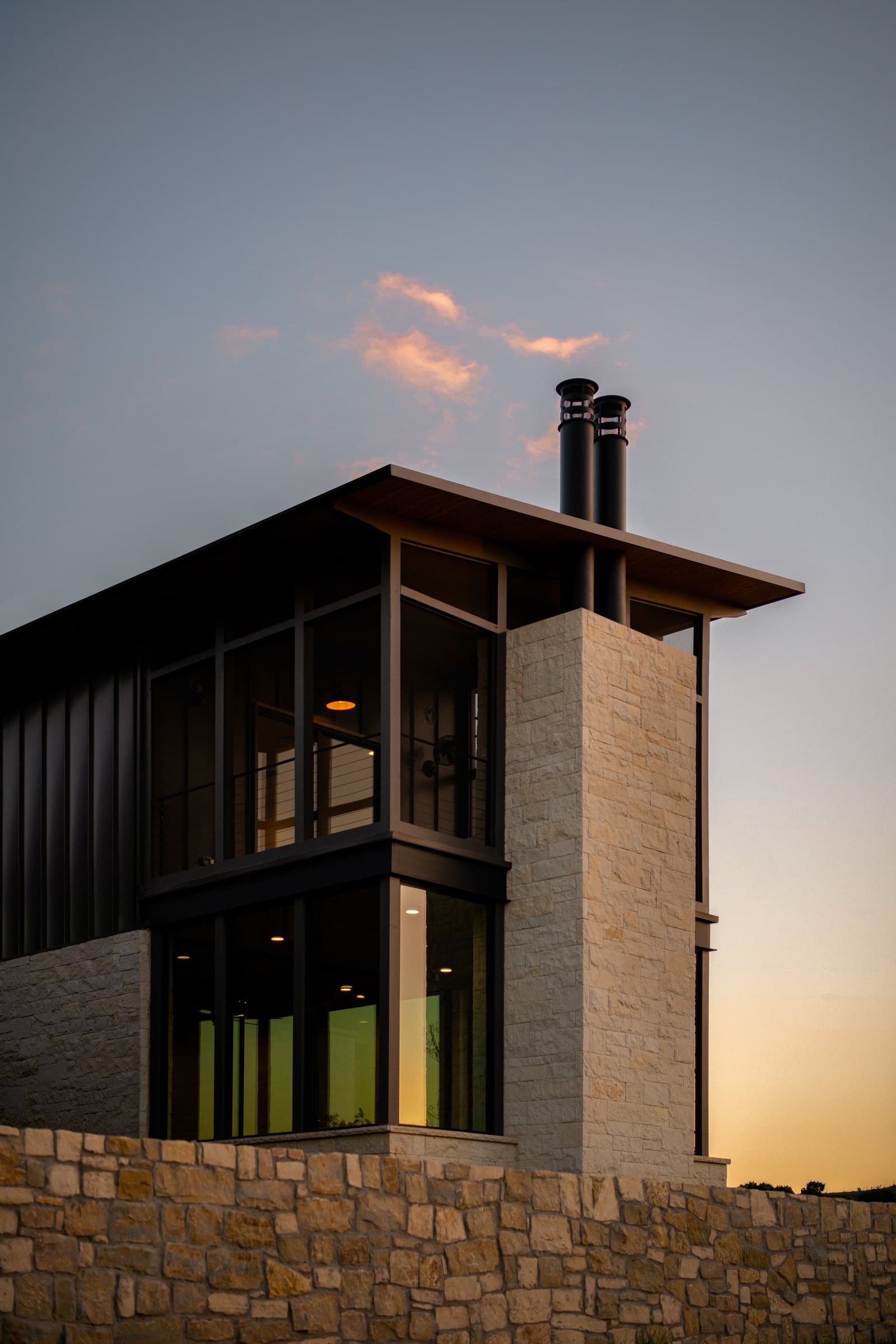 Corner of a lake home beneath a low-pitched metal roof