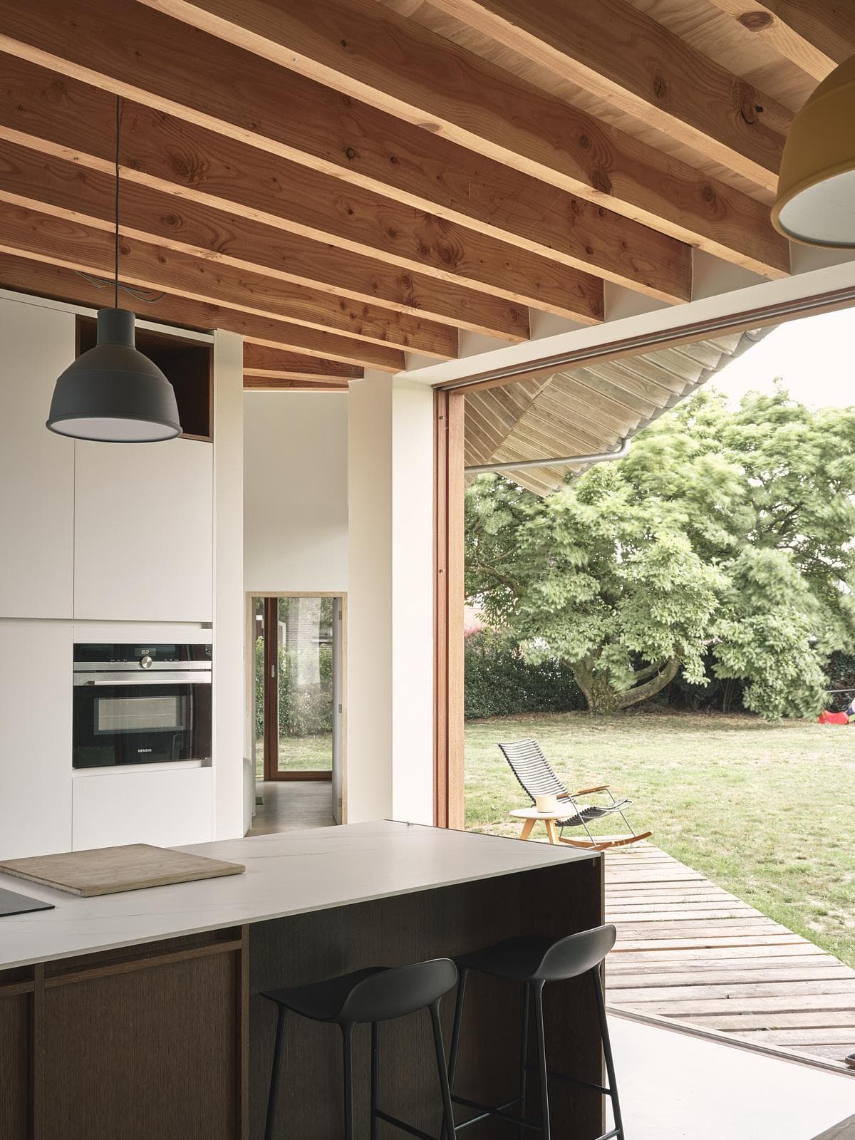Kitchen and exposed roof timbers opening towards the garden