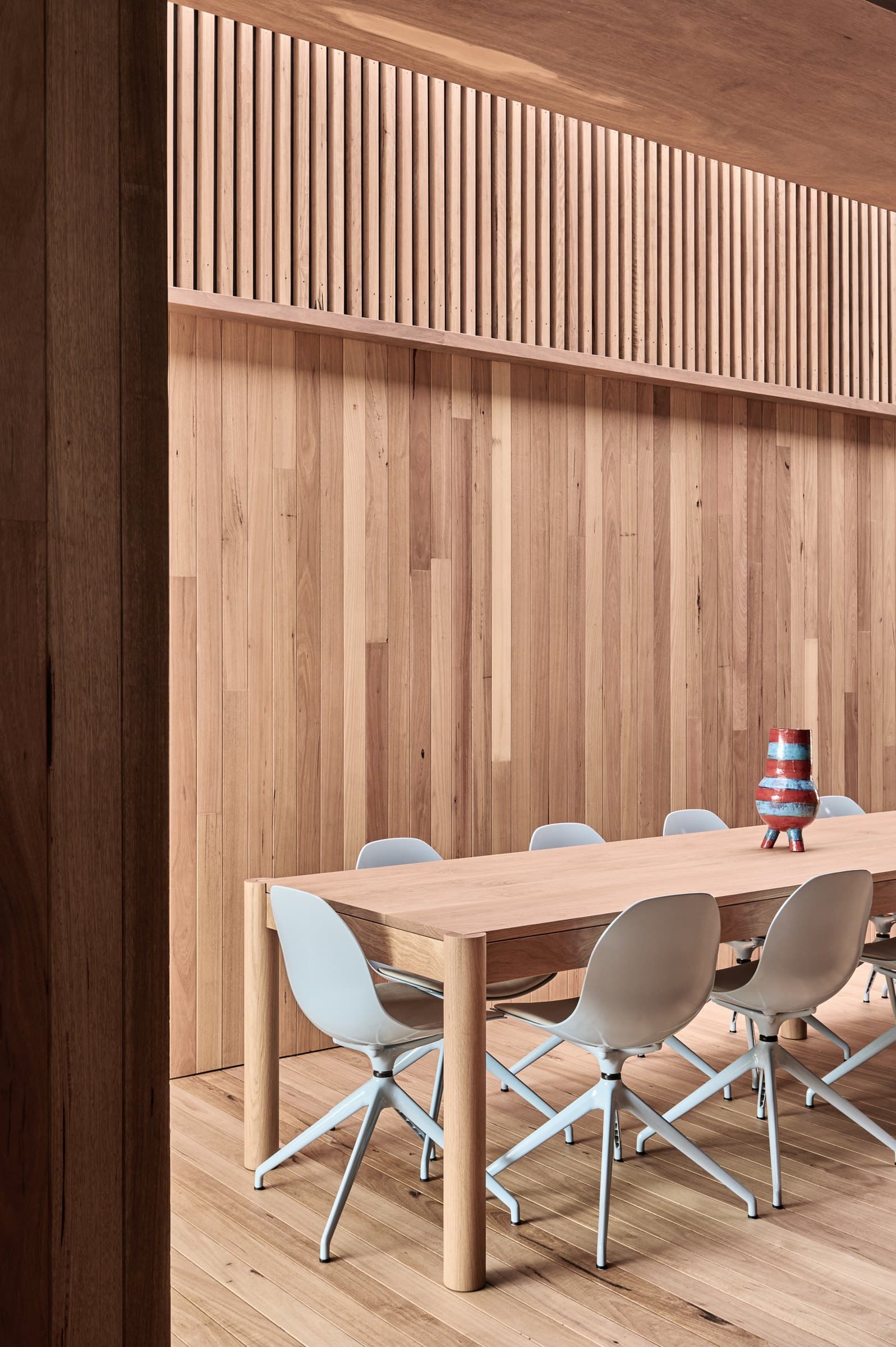 Dining room lined with timber and vertical battens