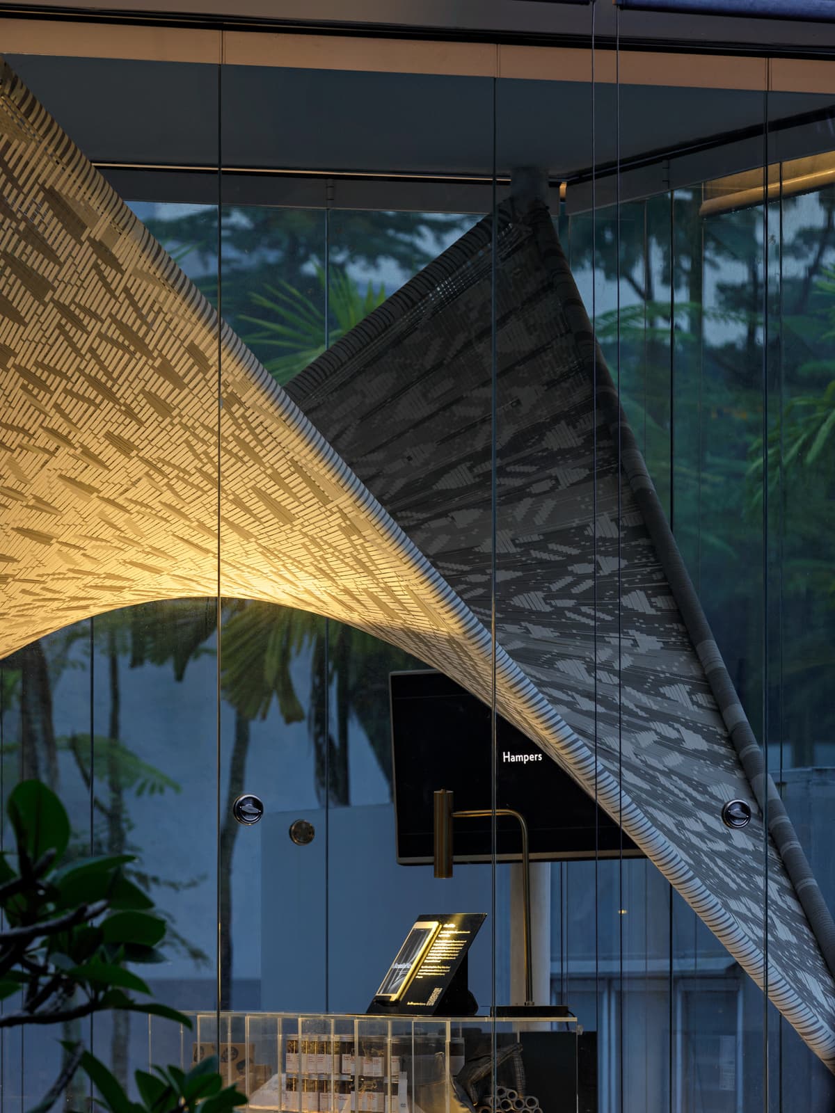 The woven fabric curves through the glazed interior.