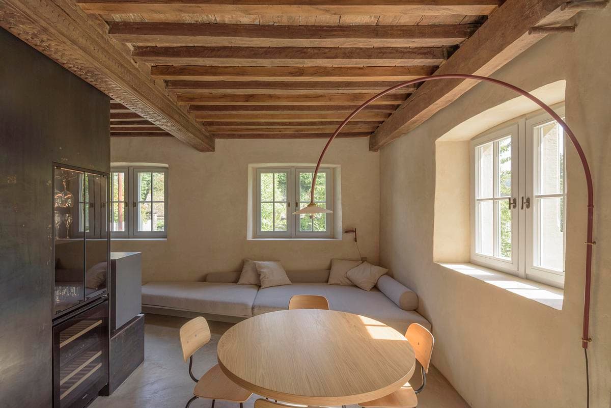 Living and dining room beneath the restored timber ceiling.