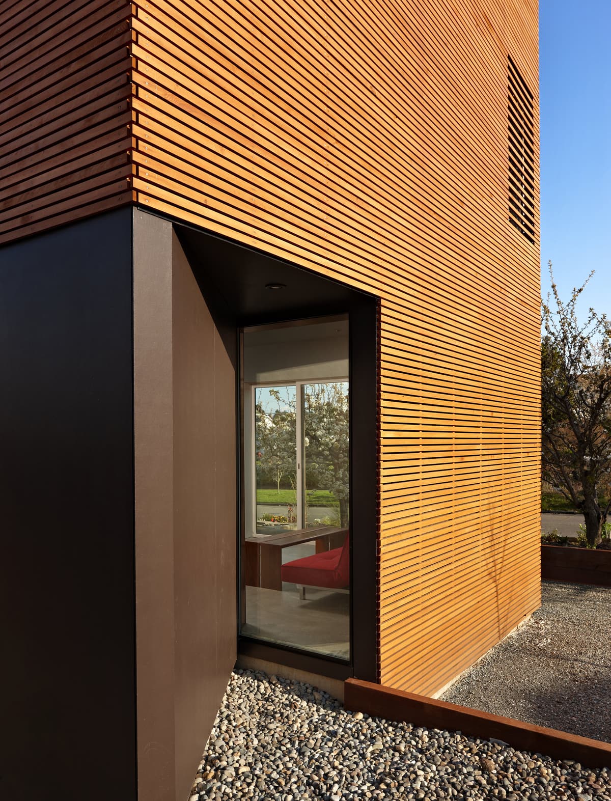 Cedar rainscreen wrapping the new upper-level volume