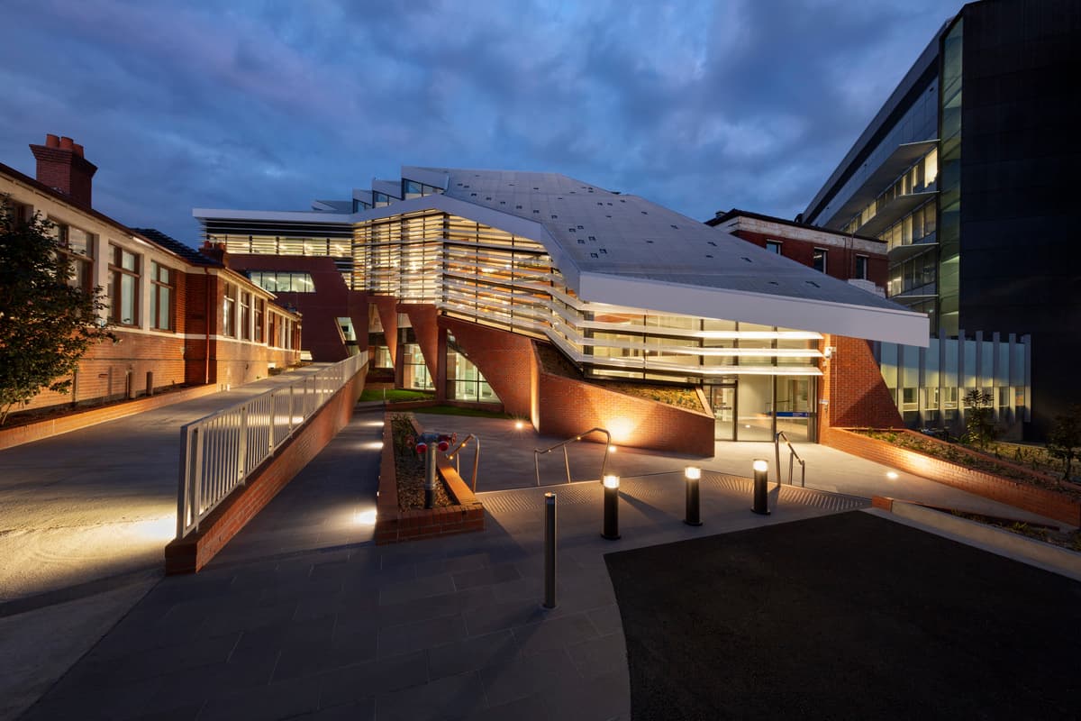 The Nancy Millis Building and external paths at dusk.
