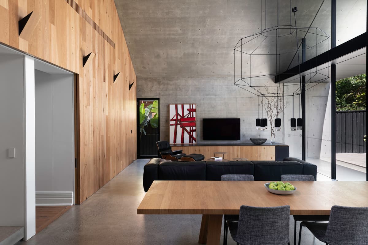 Dining and living spaces beside the timber-clad junction