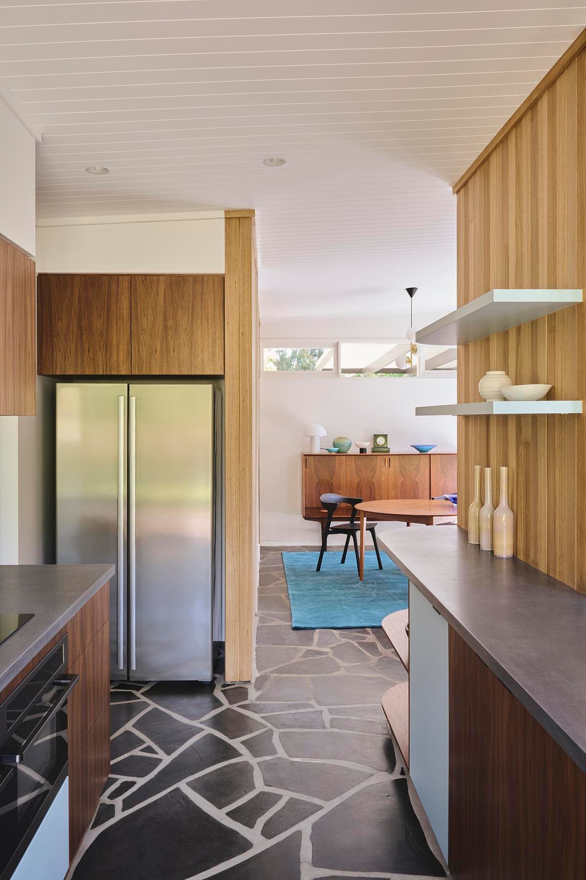 Kitchen passage beside full-height timber joinery