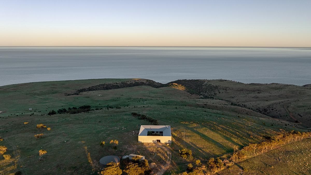 The house on its coastal hillside, with the sea beyond