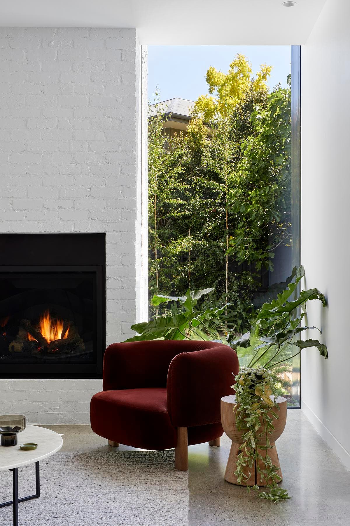 A fireplace and full-height garden opening in the living room.