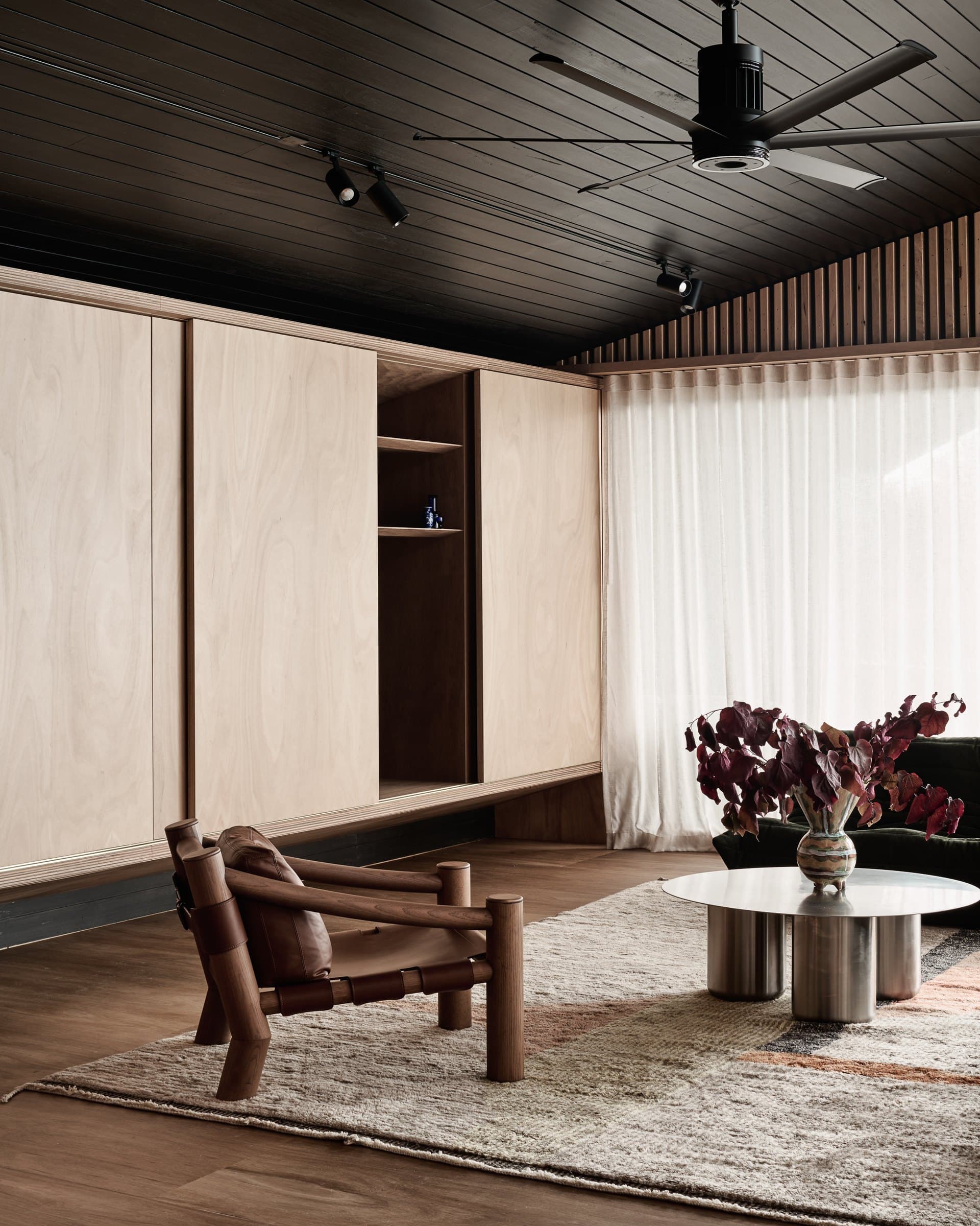 Living room with timber ceiling, joinery and garden views