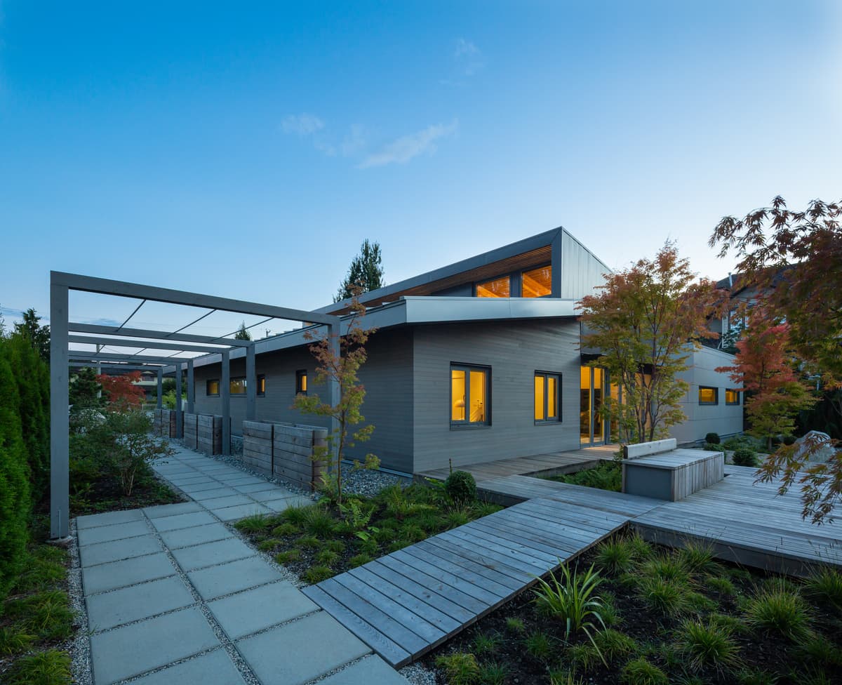Paths, a pergola and planted garden spaces connect around the house.
