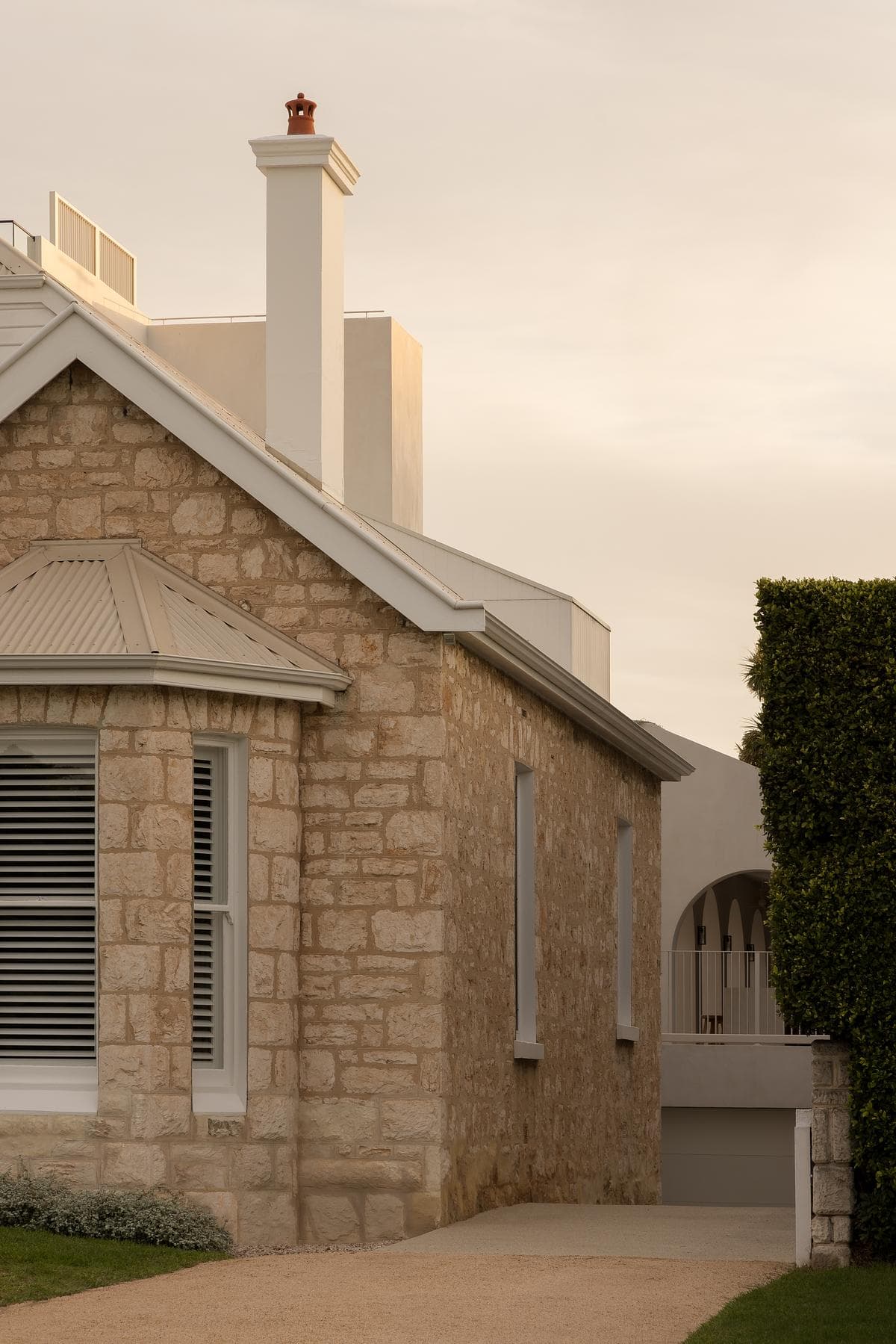 The historic stone cottage retains its gabled street frontage.