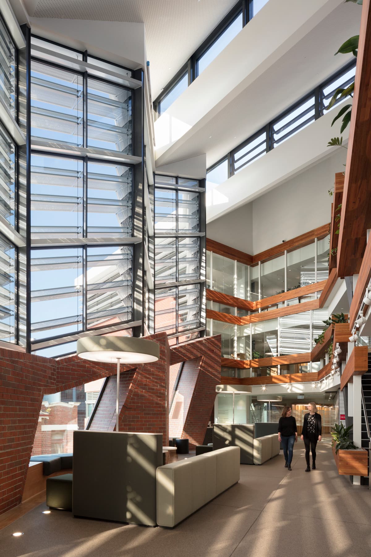 Full-height glazing and upper-level walkways in the collaboration forum.