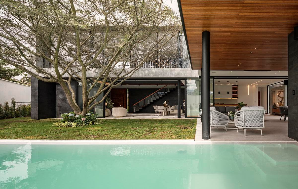 The pool sits beside the sheltered terrace and garden.