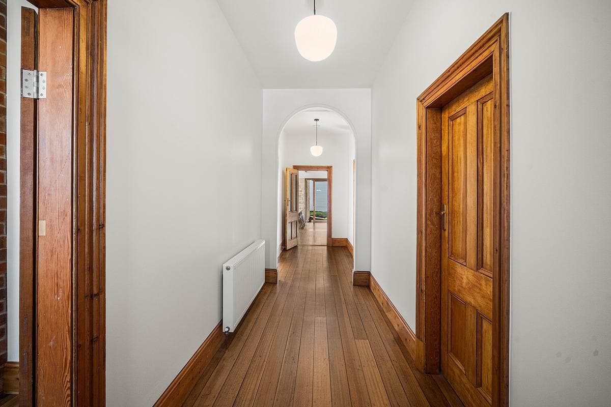 Restored timber doors line the cottage hallway.