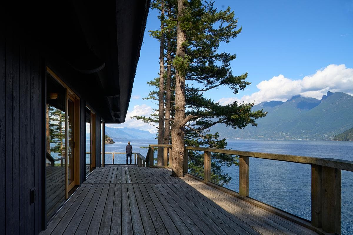 Timber deck opening towards the water and coastal mountains