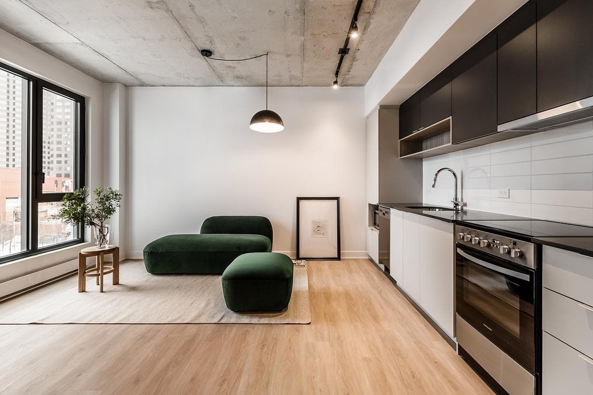 Large windows bring daylight into an apartment living room.