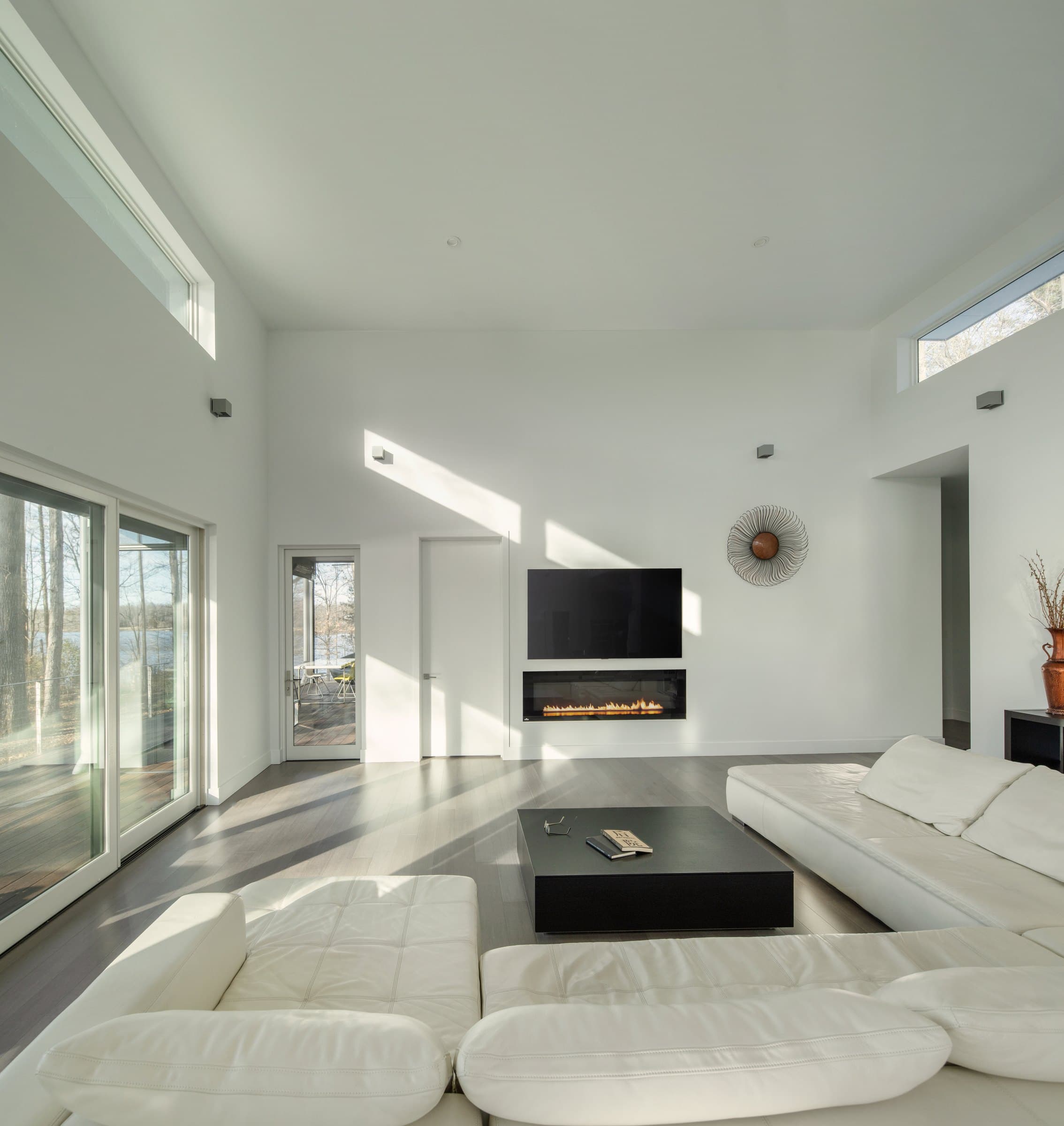 Double-height living room with glazing on both sides.