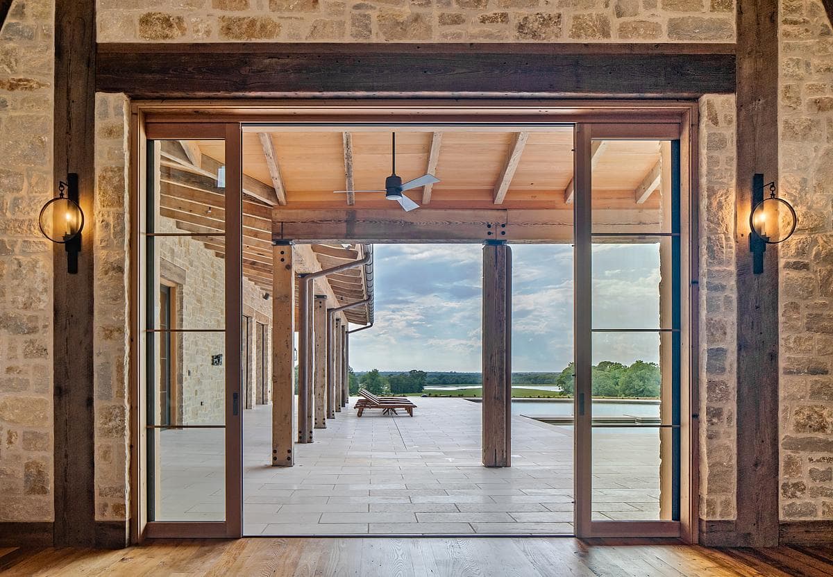 Wide pocket doors open towards the covered outdoor space.