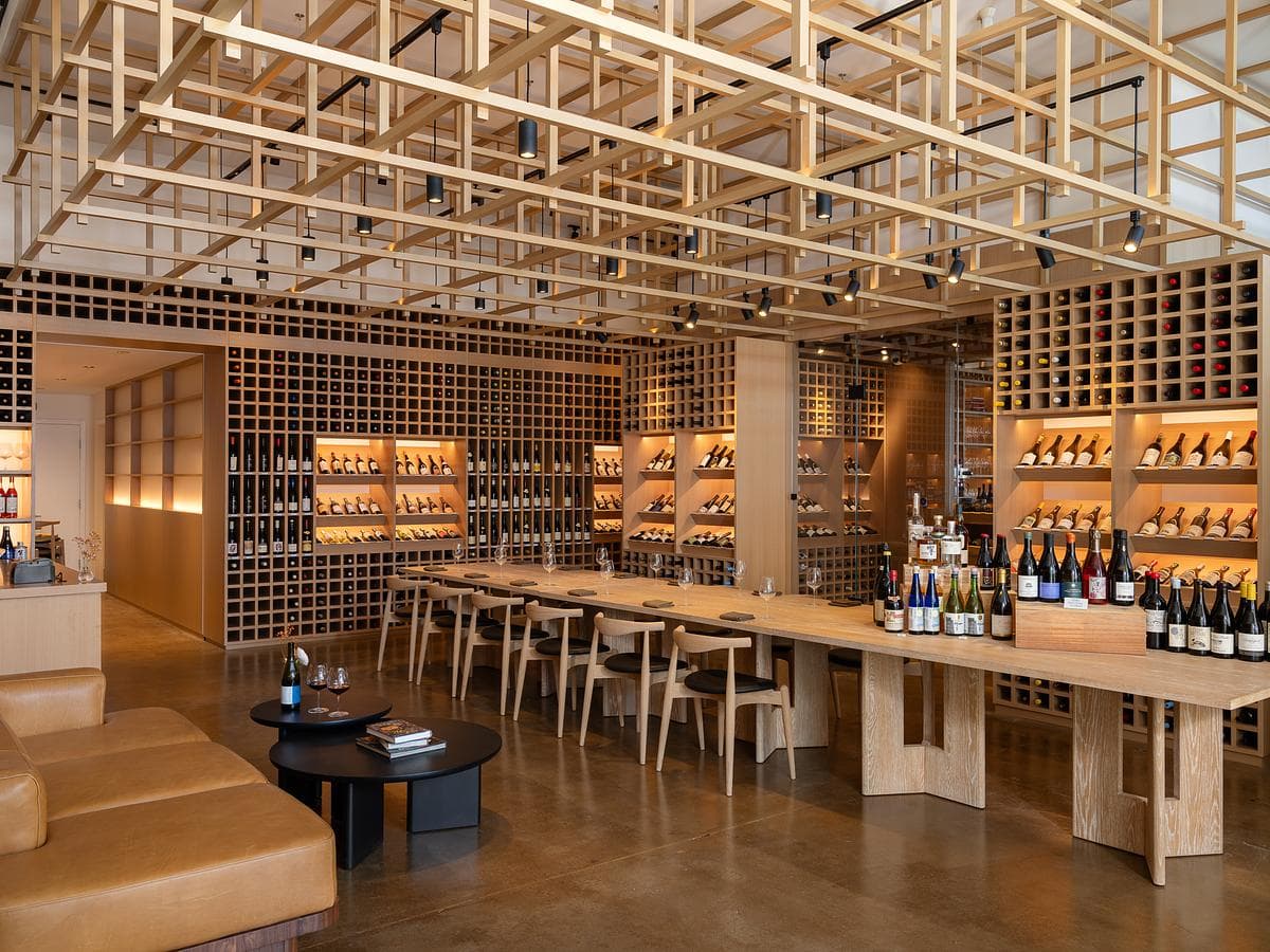Communal table beneath the suspended timber lattice
