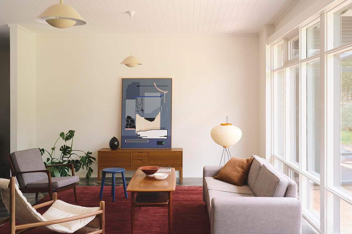Living room with full-height windows and retained slate flooring