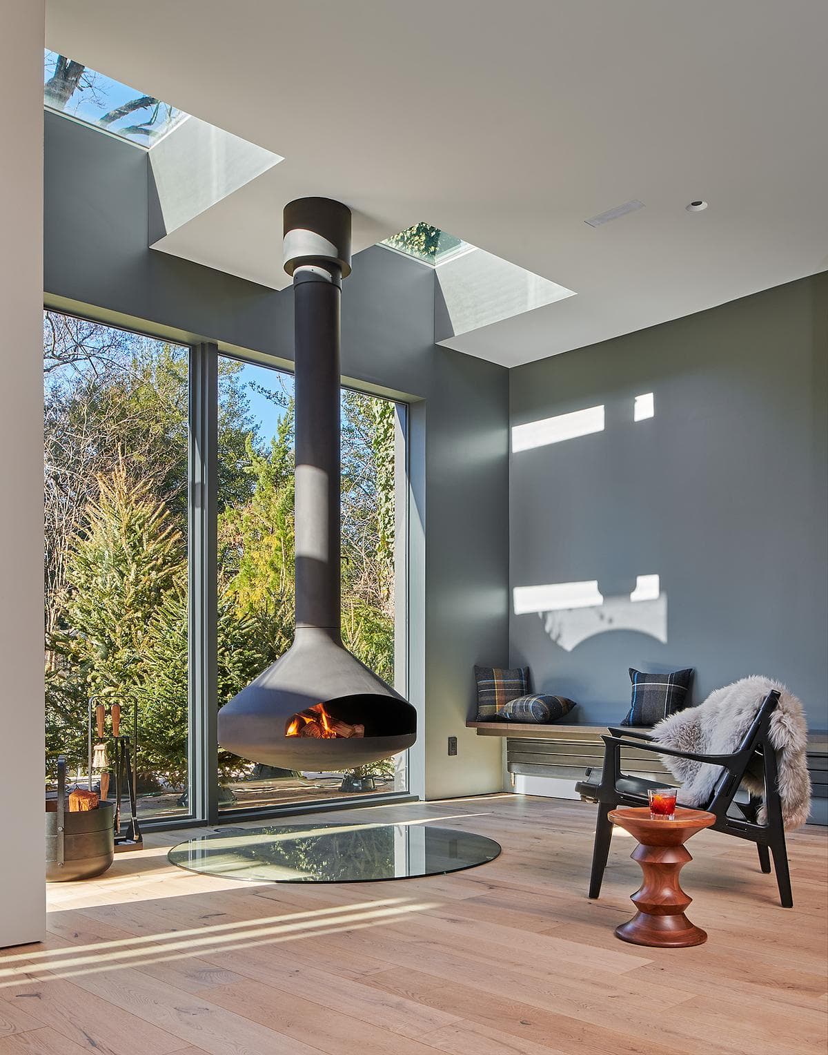 Living room with a suspended fireplace and garden-facing glazing.