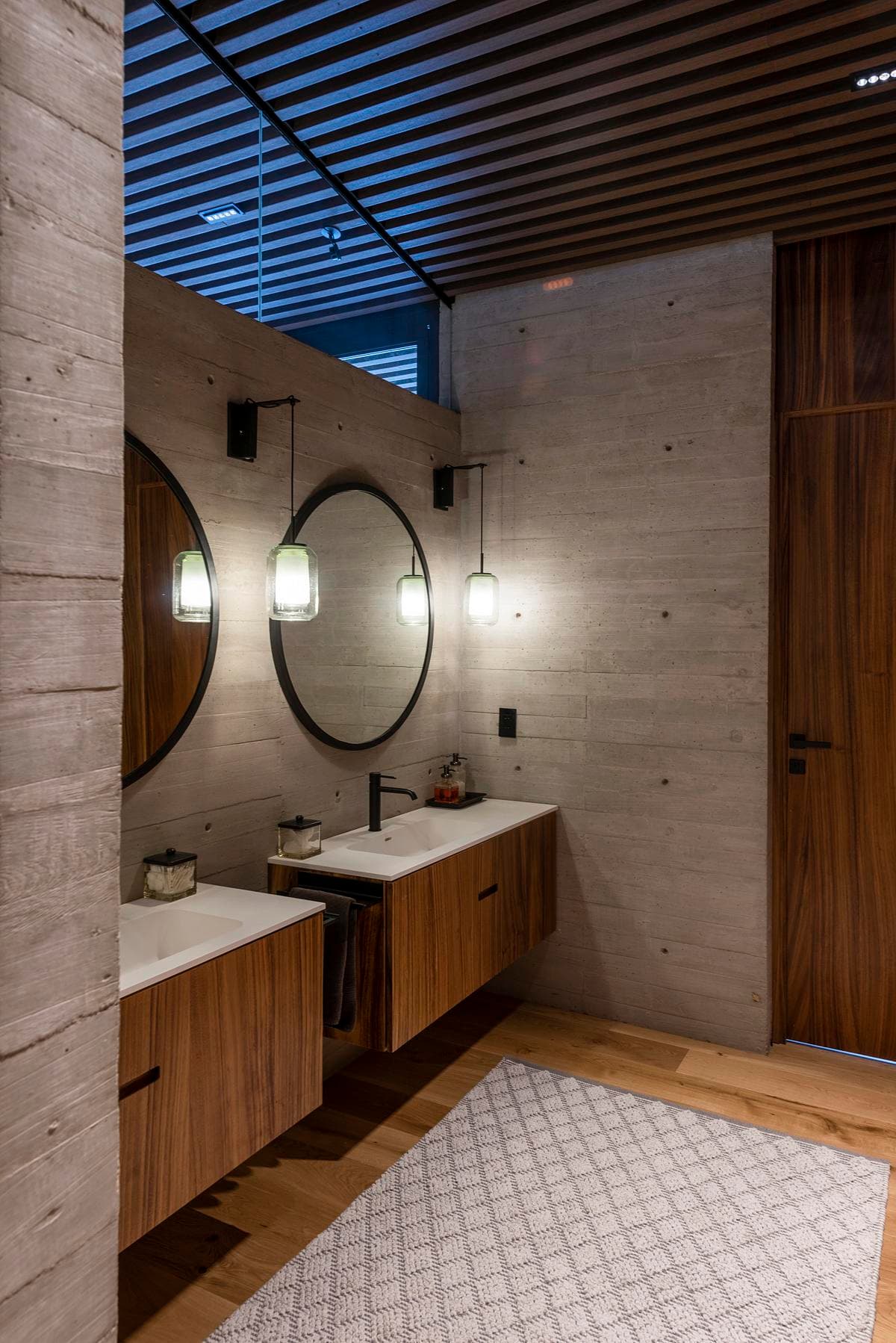 A slatted ceiling brings daylight above the bathroom vanity.