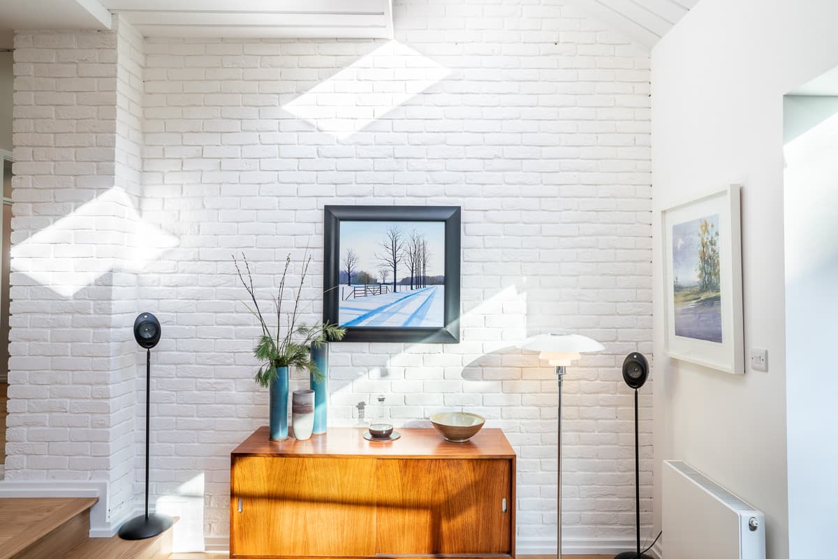 Daylight falls across the white brick interior