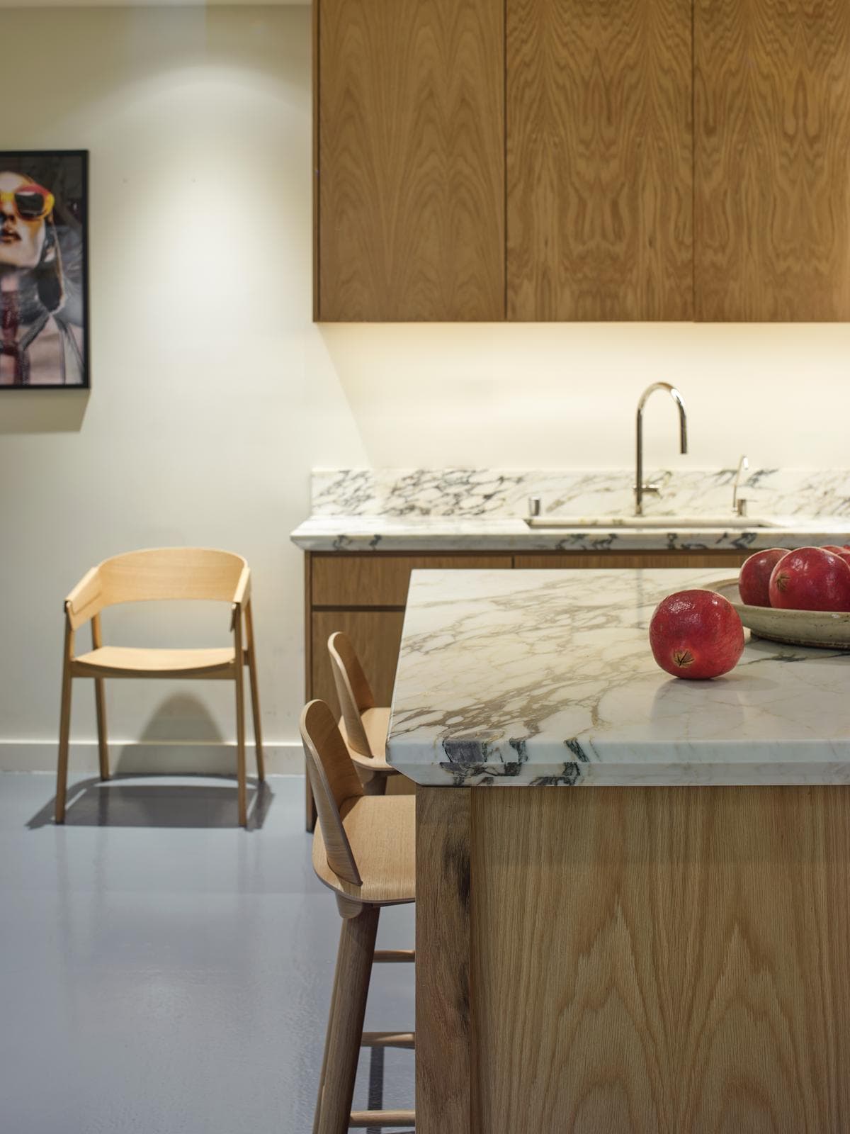 Stone counters and timber cabinetry in the workplace kitchen.