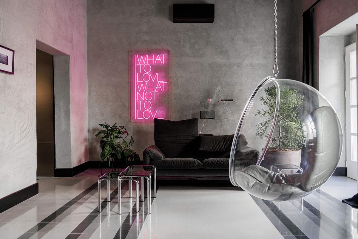 Patterned flooring, vintage furniture and a suspended chair distinguish RE.
