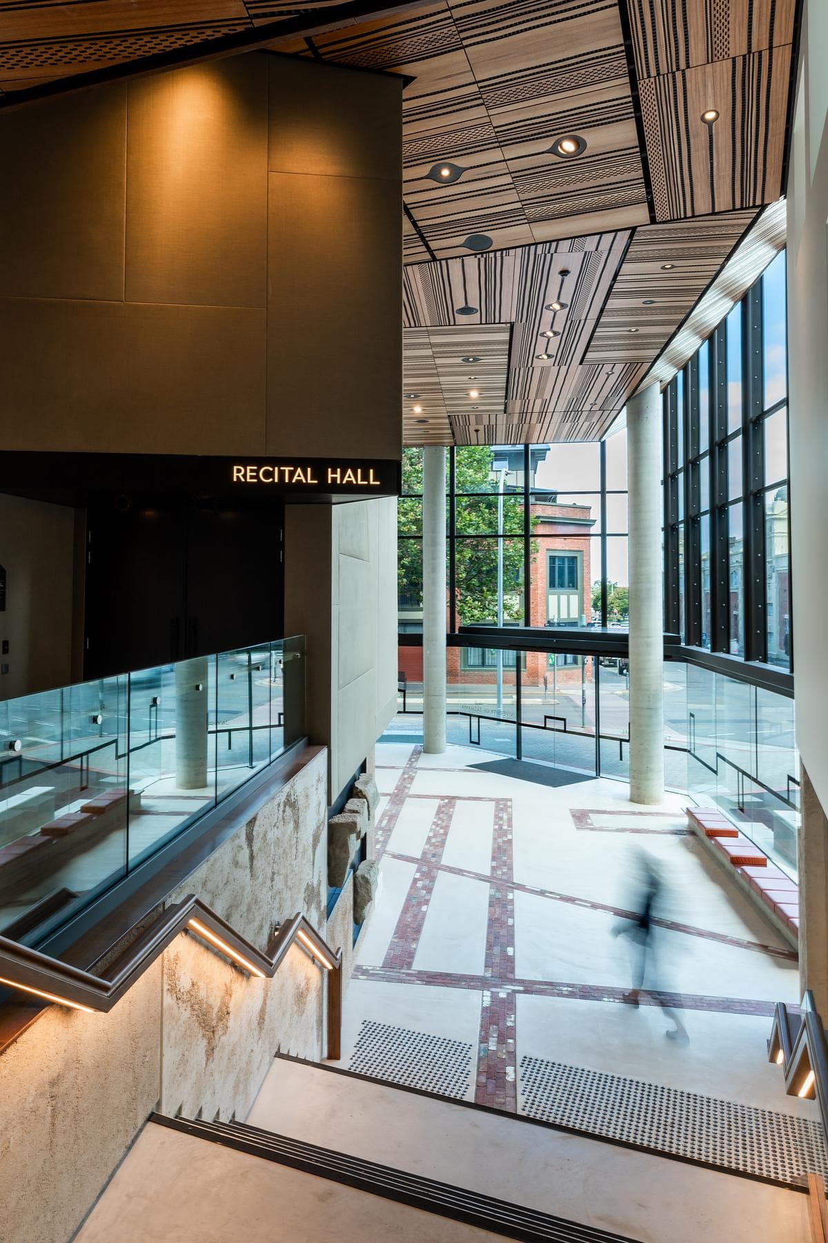 A stair and glazed landing connect the upper foyer levels.