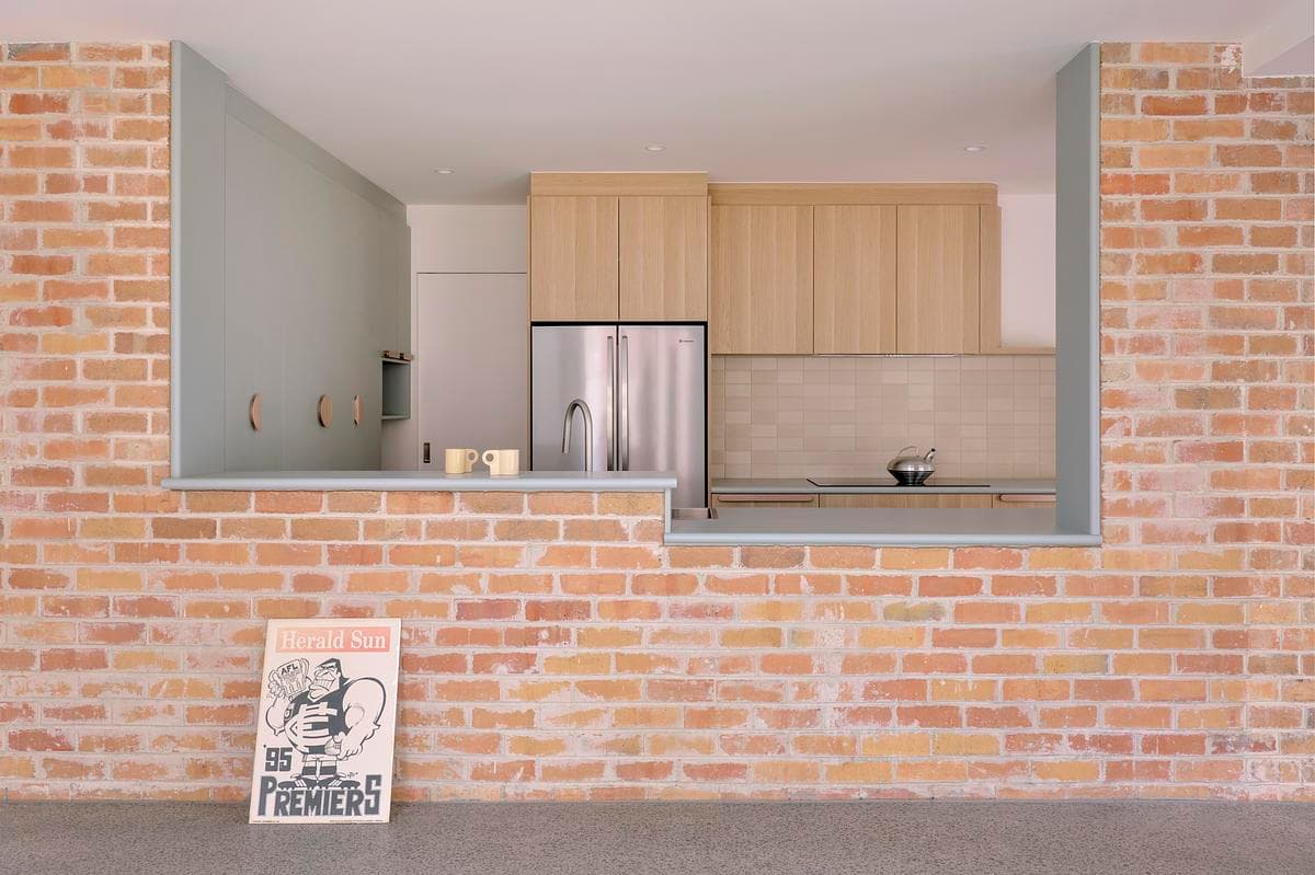 Brick opening framing the timber kitchen joinery