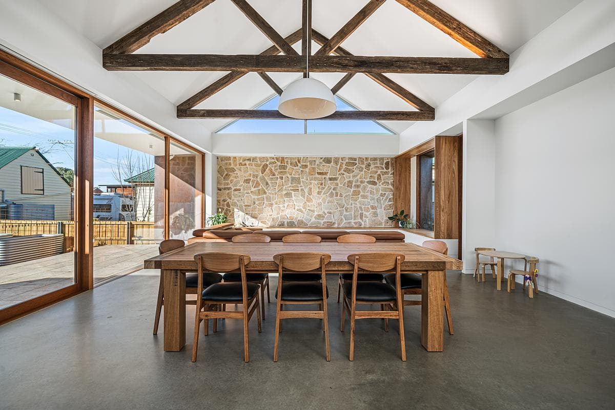 Reclaimed timber trusses span the dining area.