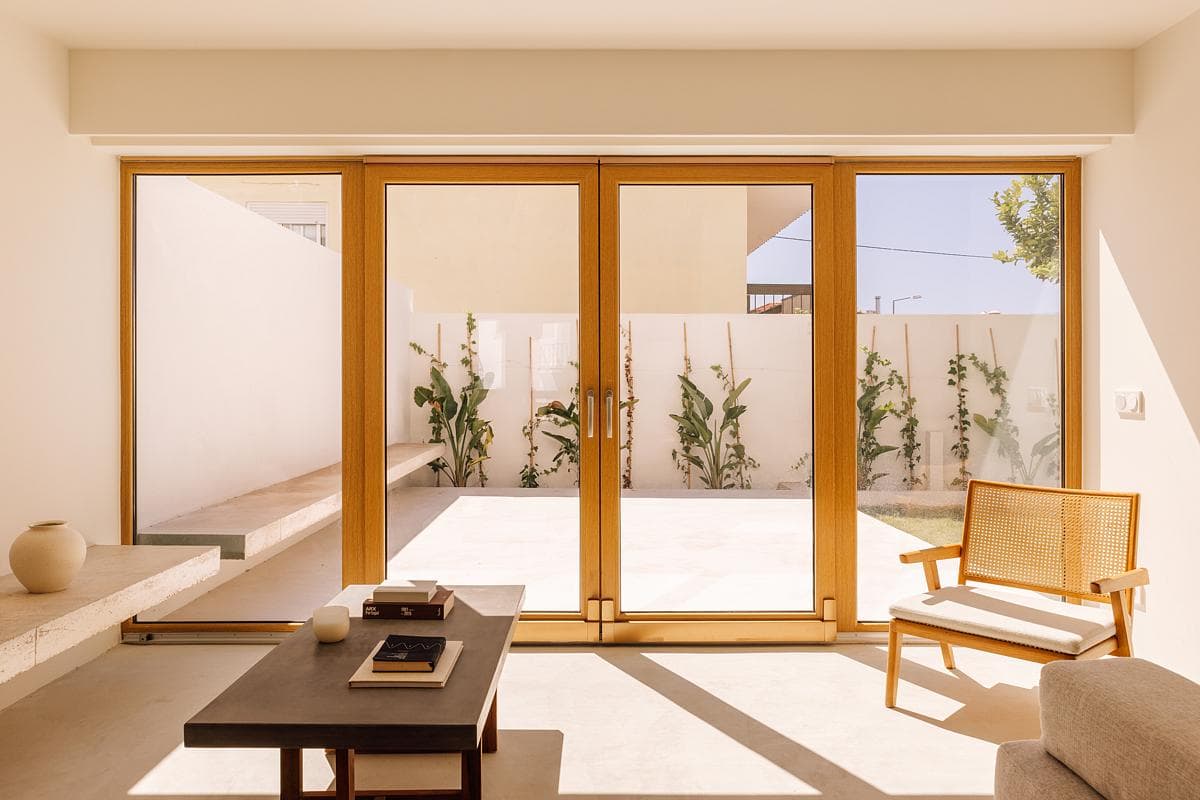 Timber-framed glazing connects the living room with the terrace.