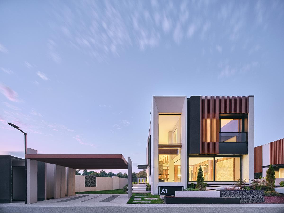 An individual villa and sheltered arrival space at dusk.