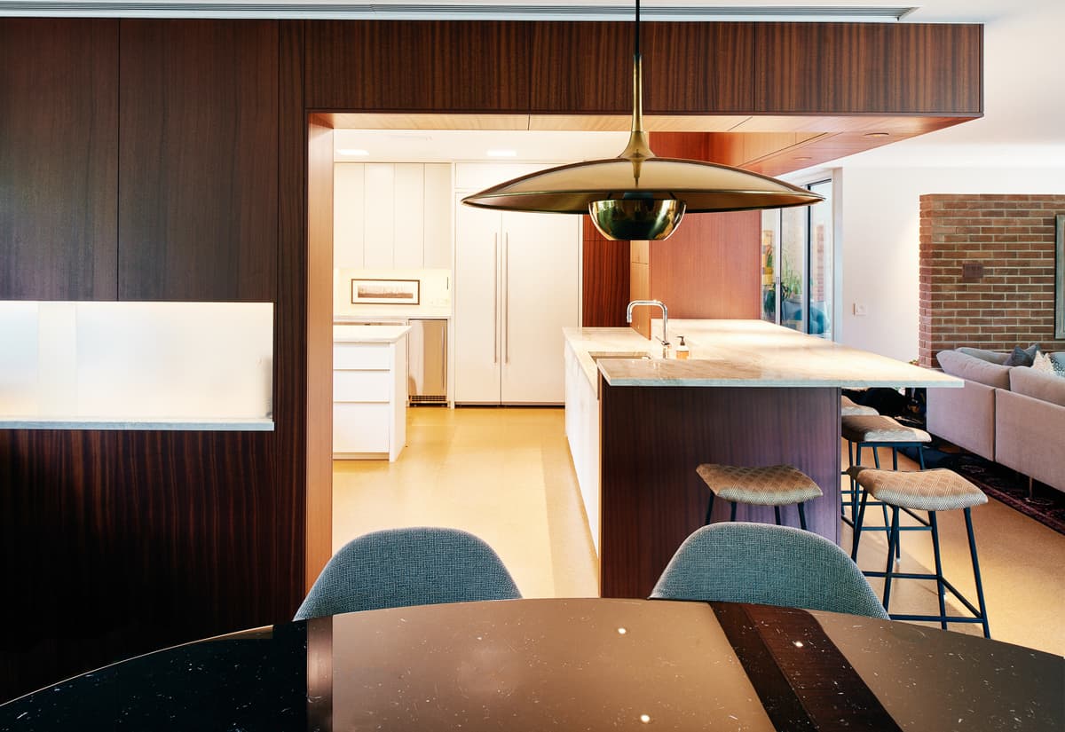 Timber panelling connects the dining area with the reworked kitchen.