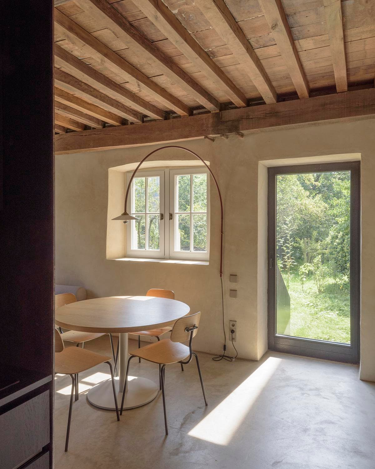 Dining corner beside the garden door and plastered walls.