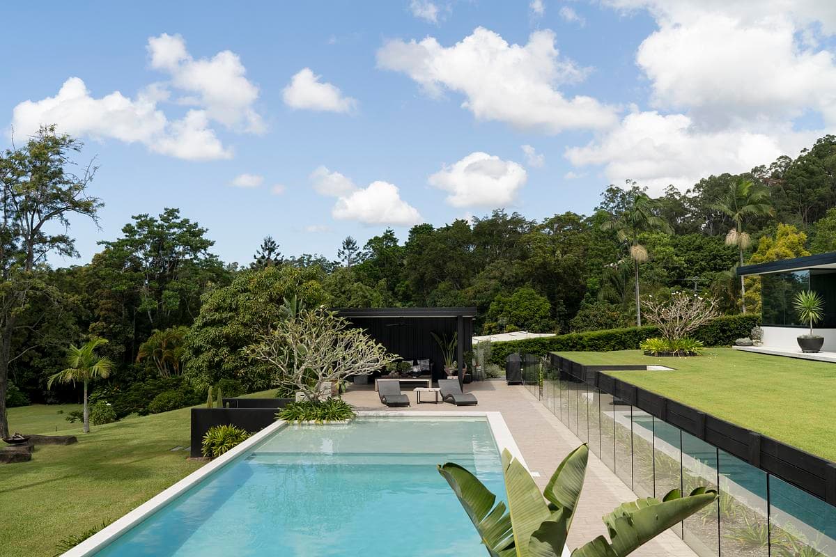 Pool and cabana set into the sloping garden.